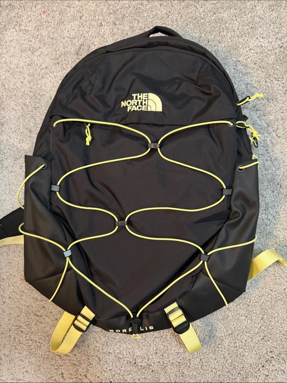 The North Face Black Backpack with Yellow Bungee and Straps